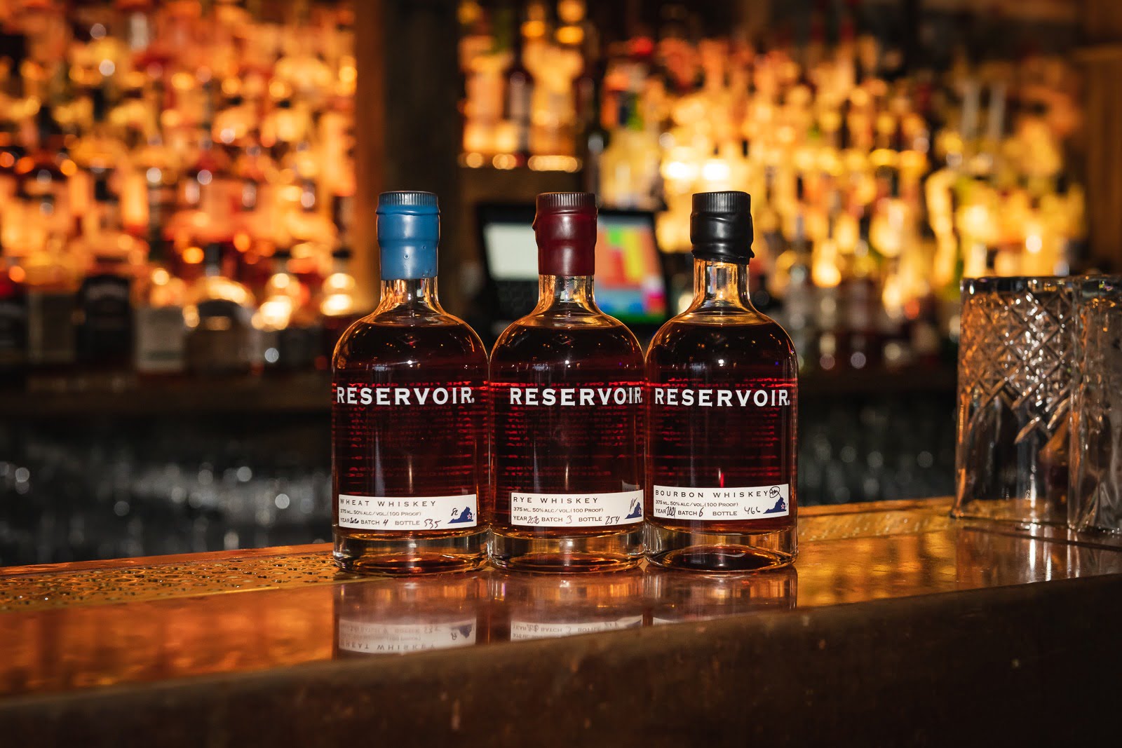 Three Bottles of Reservoir Bourbon Whiskey on the NOLA Bar